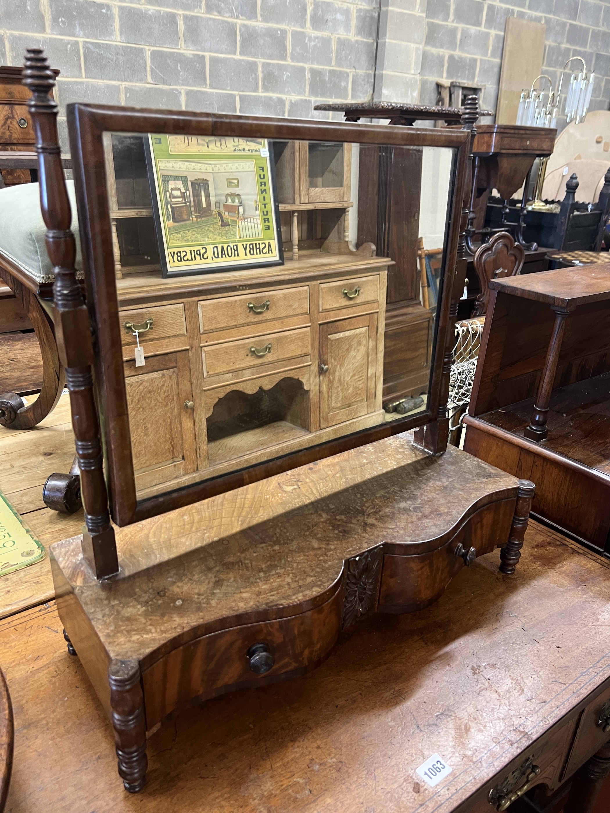 A Regency mahogany kneehole dressing table, width 94cm, depth 50cm, height 72cm together with an early Victorian mahogany serpentine front toilet mirror